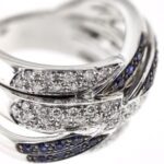 zoom dettaglio anello in oro bianco a fascia incrociata con diamanti e zaffiri